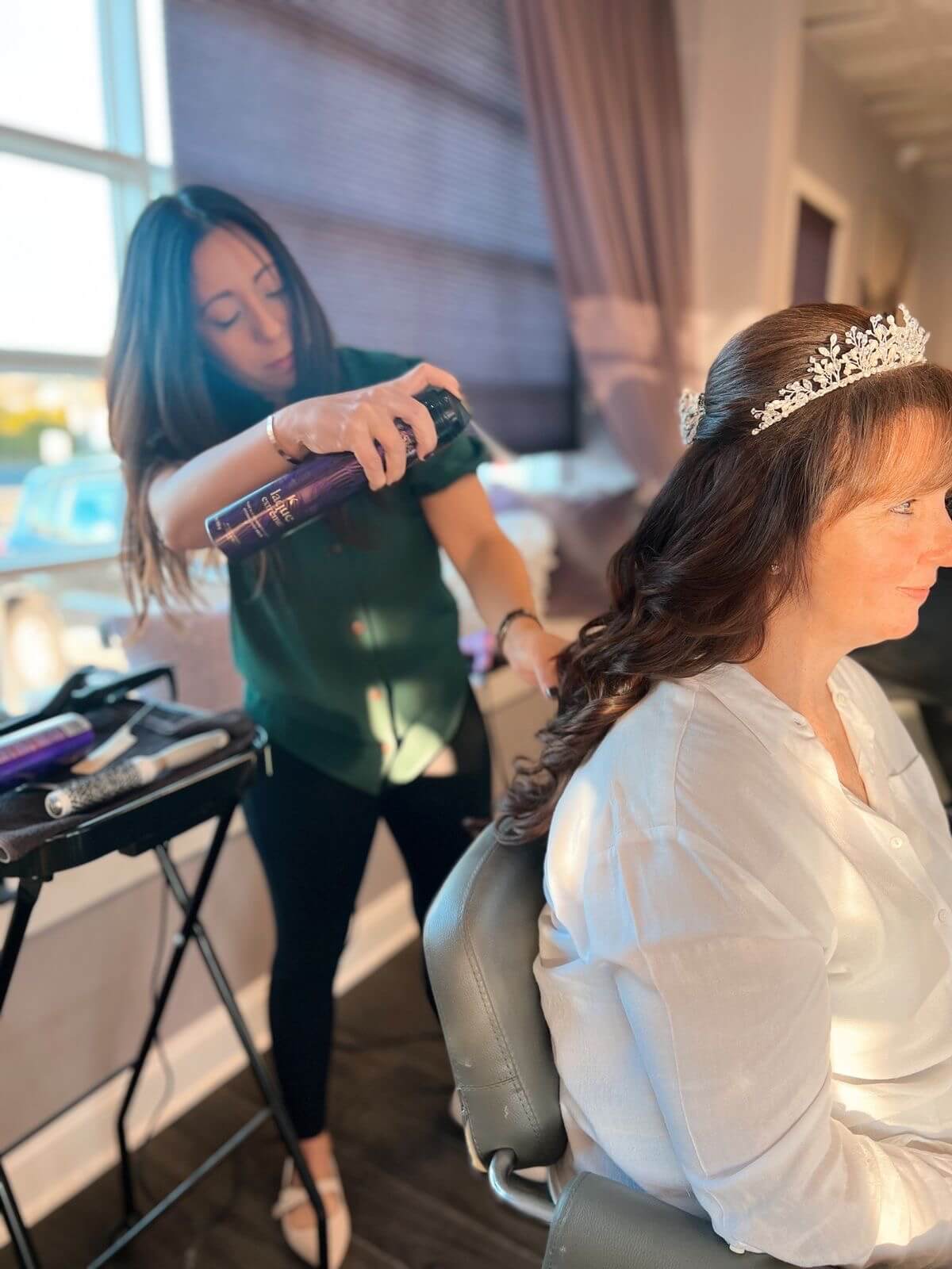 Makeup Artist Using Hair Spray On A Bridal Hair